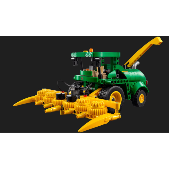 Side view of a green and yellow John Deere 9700 Forage Harvester LEGO Technic model with a large front forage header.