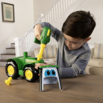Front-side view of a green John Deere Build-A-Buddy tractor with yellow wheels and a green toy drill.
